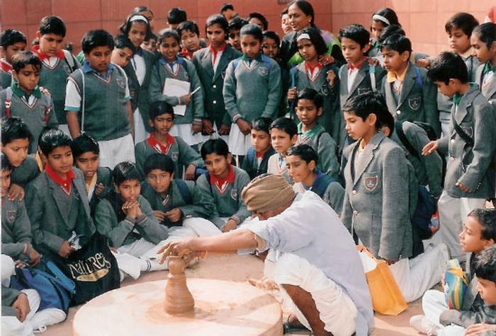 school children viewing a local potter at work
