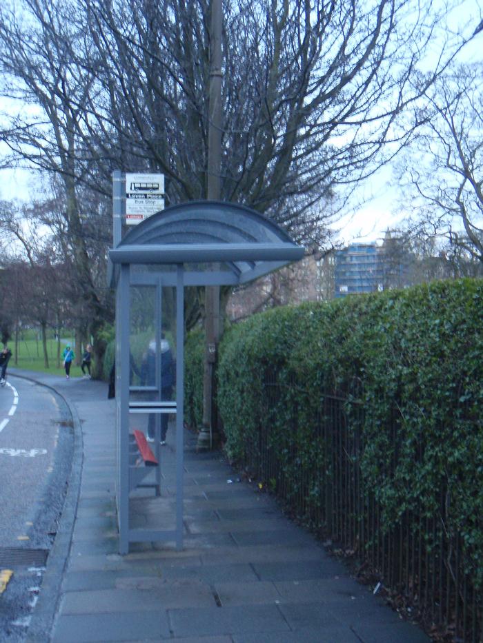 This bus shelter halves the already narrow sidewalk