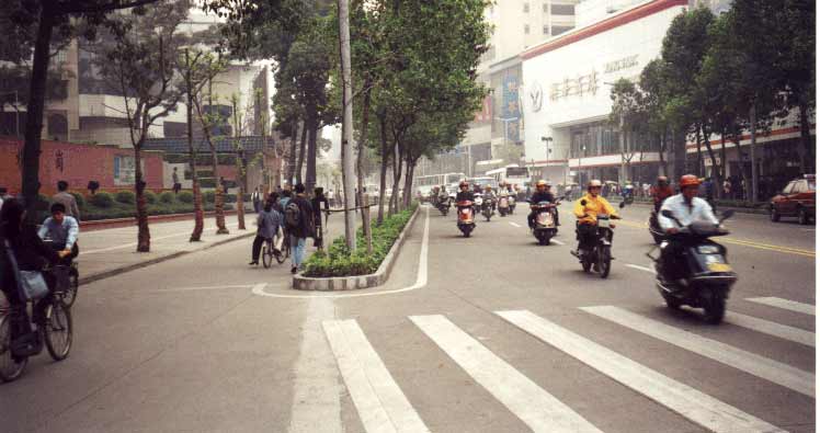 An accessible travel chain begins with safe streets and sidewalks. This street in Foshan, China, has separate rights-of-way for pedestrians, human-powered vehicles, and motor-powered vehicles.