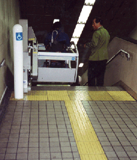 Stairs are often retrofitted with stair lifts in transit terminals, as here in a Tokyo subway station. However, in new construction, elevators should be considered where possible.