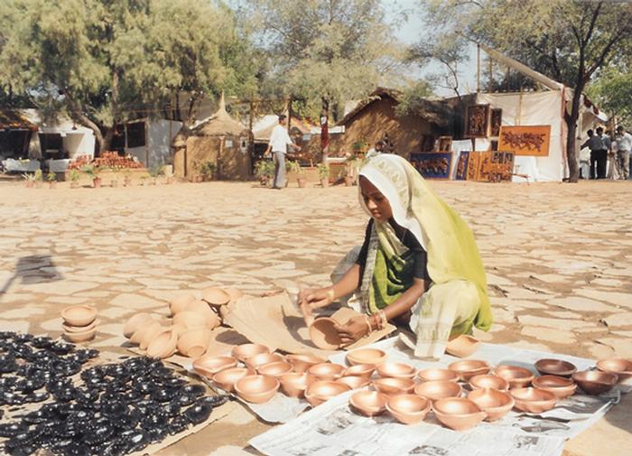 local artist assembling her wares in shilpagram