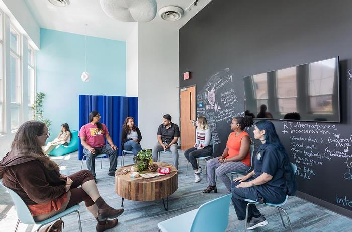 Photo of peacemaking circle in Restore Oakland facility, designed by DJDS architects